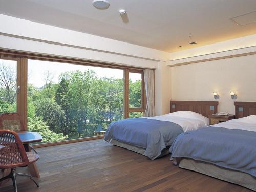 Ένα ή περισσότερα κρεβάτια σε δωμάτιο στο Hokkaido Hotel