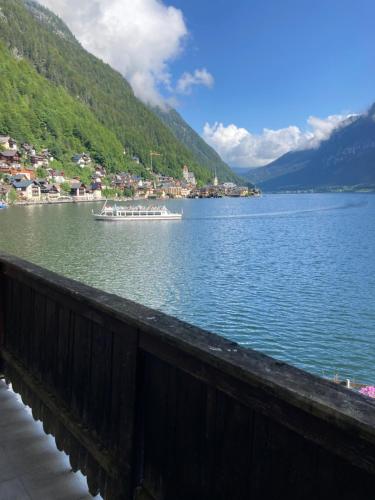 a boat on a large body of water at Hallstatt Lakeside Top 4 - Zimmer mit Balkon in Hallstatt