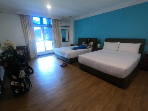 Postel nebo postele na pokoji v ubytování Bukit Beruntung Resort