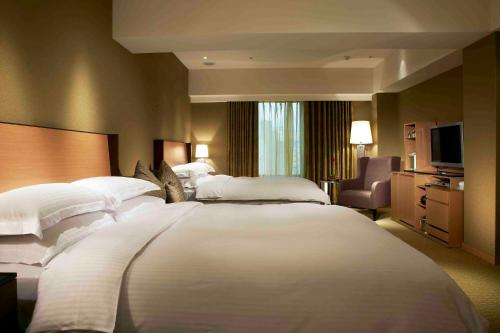 Кровать или кровати в номере City Suites-Taipei Nanxi