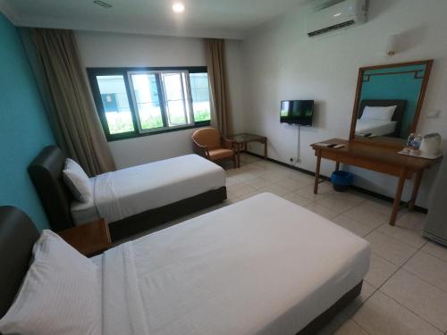 Postel nebo postele na pokoji v ubytování Bukit Beruntung Resort