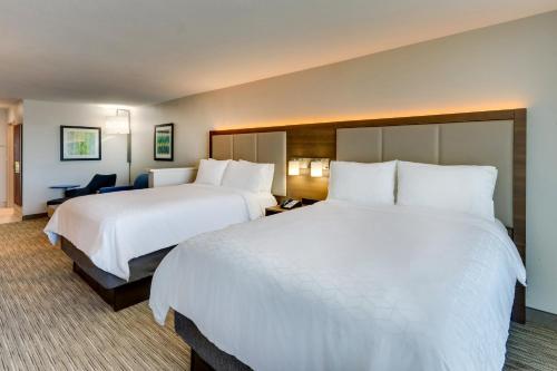 two beds in a hotel room with white sheets at Holiday Inn Express Lake Worth NW Loop 820 by IHG in Fort Worth