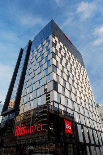 a tall building with the tbs industries sign on it at ibis Adelaide in Adelaide