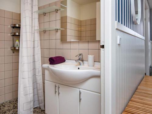 a bathroom with a sink and a mirror at 6 person holiday home in Ringkøbing-By Traum in Ringkøbing