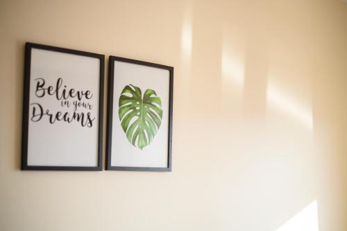 three framed prints of a plant on a wall at Apartman Jaman - Novi Pazar in Novi Pazar
