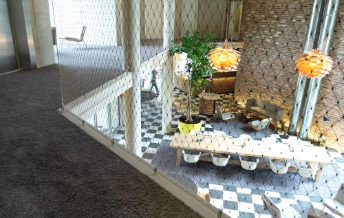 a model of a building with a table and a plant at Flowers Hotel Essen in Essen