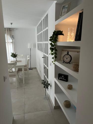 a hallway with white shelves and a dining room at Altea Lighthouse in Altea