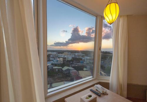 a large window with a view of a city at Kenting Long Beach Hotel in Checheng