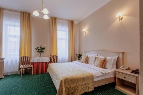 a hotel room with a bed and a table at Hotel Kupechesky in Krasnoyarsk