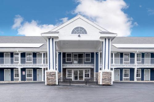 a large white building with a lot of windows at Hilltop Inn & Suites - North Stonington in North Stonington