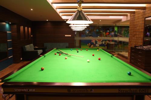 a pool table with balls on it in a room at Radisson Resort & Spa Kandla in Gandhidham