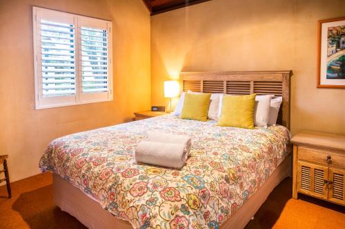 a bedroom with a large bed and a window at Whalers Cove Villas in Dunsborough