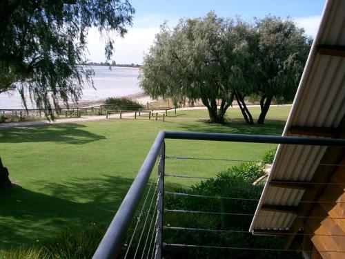 a balcony of a house with a view of the beach at Whalers Cove Villas in Dunsborough
