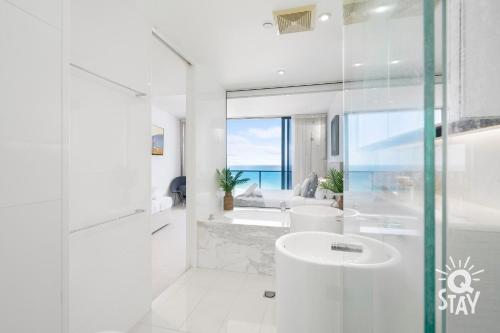 Baño blanco con lavabo y bañera en LIMITED 7 NIGHT DEAL 4 Bedroom Sub Penthouse Ocean Views at Oracle - KIDS STAY FREE!!!, en Gold Coast