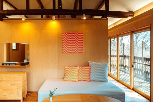 a bedroom with a bed with a flag on the wall at ROKKONOMAD in Kobe