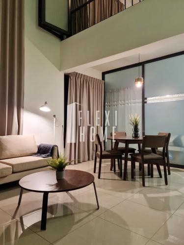 a living room with a couch and a table at Spacious Big Room, Designed & Quiet Family Home, Eclipse in Cyberjaya by Flexihome-MY in Cyberjaya