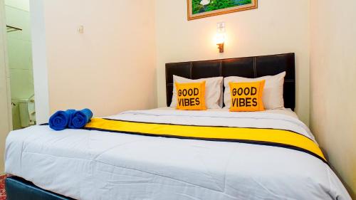 Postel nebo postele na pokoji v ubytování Horton Hotel Cirebon
