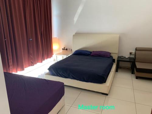 a bedroom with a bed and a chair at BEDONG GOLF VILLA in Bedung