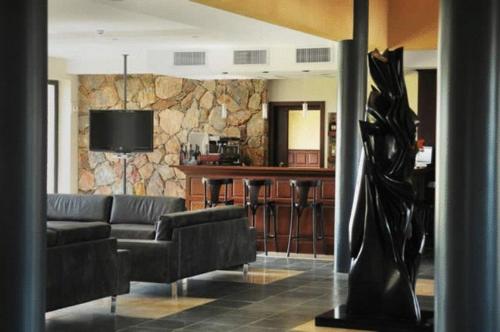 a living room with a couch and a bar at Regency Park Hotel in Montevideo