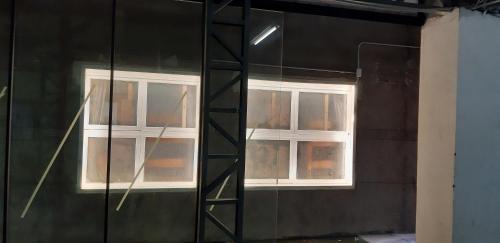 a room with two windows in a building at 藏風民宿THE WIND GUESTHOUSE 2022 in Tainan
