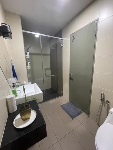a bathroom with a shower and a sink and a toilet at LakePark Residence KL North in Batu Caves