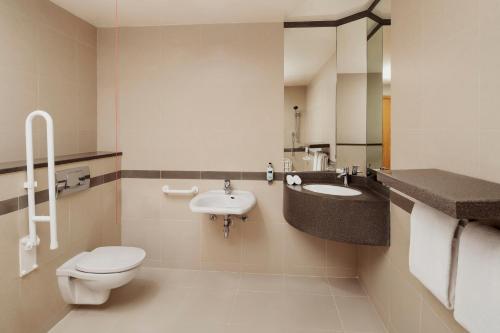 a bathroom with a toilet and a sink at Holiday Inn Express Dubai Airport by IHG in Dubai
