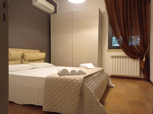 a bedroom with a bed with two towels on it at B&B Terra Cesarea in Santa Cesarea Terme