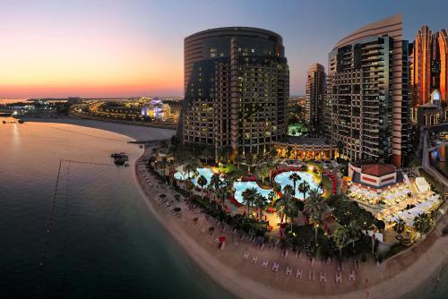 an aerial view of a city at night at Khalidiya Palace Rayhaan by Rotana, Abu Dhabi in Abu Dhabi