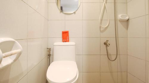 a bathroom with a toilet and a shower at RedDoorz @ Eros Travellers Pensione in Iloilo City