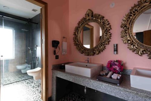 a bathroom with a sink and a mirror at The Atman Dharamshala by Leisure Hotels in Dharamshala