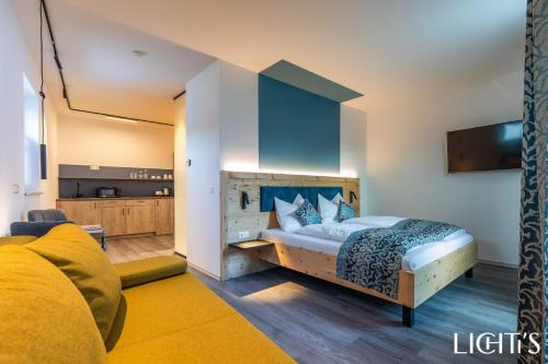 a bedroom with a large bed and a tv at Lichti´s Rooms & Appartements in Aspang Markt