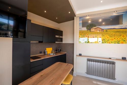 a kitchen with a wooden table and a painting on the wall at Domus Aurelia in Rome
