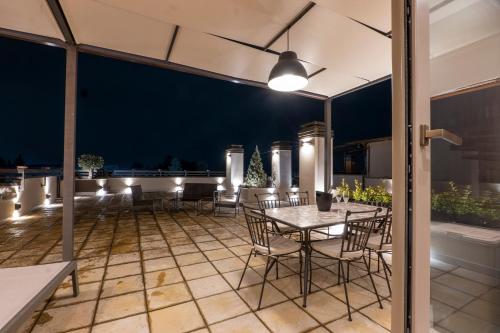 an outdoor patio with a table and chairs at Domus Aurelia in Rome
