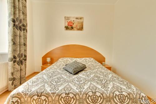 a bedroom with a bed with a pillow on it at Luxury Suites - Tatari by Rikas Hotels in Tallinn