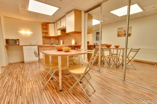 a kitchen and dining room with a table and chairs at Luxury Suites - Tatari by Rikas Hotels in Tallinn