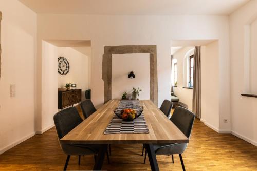 a dining room with a wooden table and chairs at Pension Donatus in Pirna