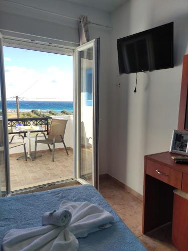 a room with a bed with a view of the ocean at Villa Paris in Xerokampos