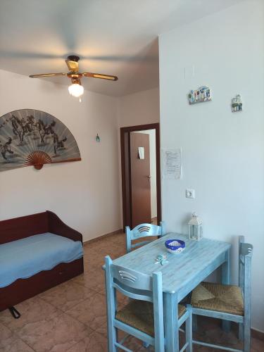 a room with a blue table and a bed at Villa Paris in Xerokampos