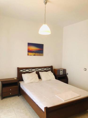a bedroom with a bed and a pendant light at fanis sweet home in Kampos Paros