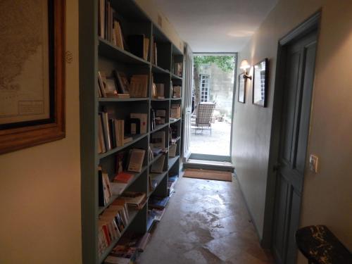 a hallway with book shelves filled with books at Face au Palais in Avignon