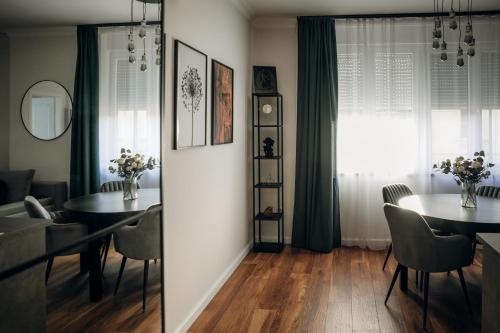 a dining room with a table and chairs and a window at B15-Blue Lagoon in Győr