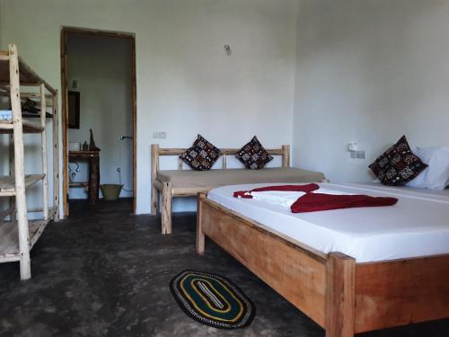a bedroom with two beds and a bunk bed at BONDENI BEACH HOUSE in Jambiani
