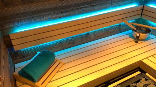 a bench in a sauna with blue lights on it at Alpfee Lechtal in Bach
