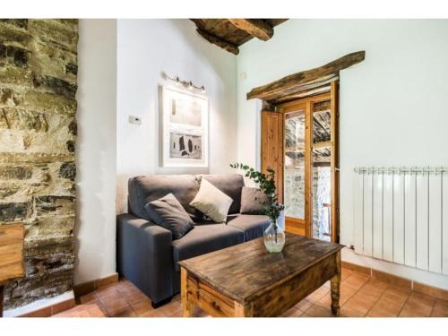 a living room with a couch and a coffee table at Casas Rurales Molinias in Fosado