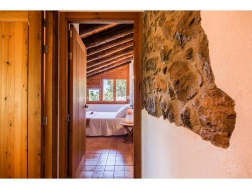 a doorway to a bedroom with a bed and a window at Casas Rurales Molinias in Fosado