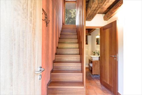 a staircase in a home with wooden floors at Casas Rurales Molinias in Fosado