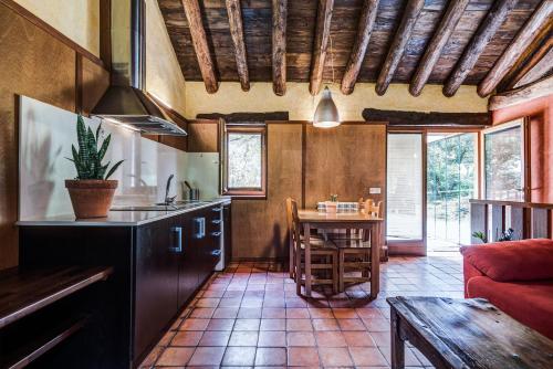 a kitchen with a table and a couch in a room at Casas Rurales Molinias in Fosado