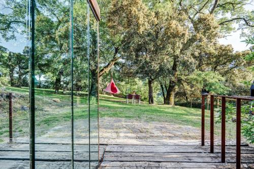 a glass door with a park in the background at Casas Rurales Molinias in Fosado