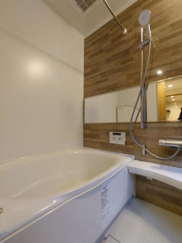 e bagno con vasca e specchio. di 柏 花小七 Haku Flowers Seven a Kyoto