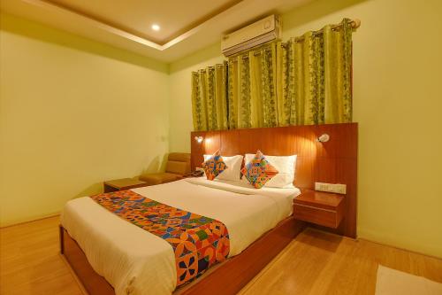 a bedroom with a bed and a window at FabHotel The BTM Palace - BTM Layout in Bengaluru